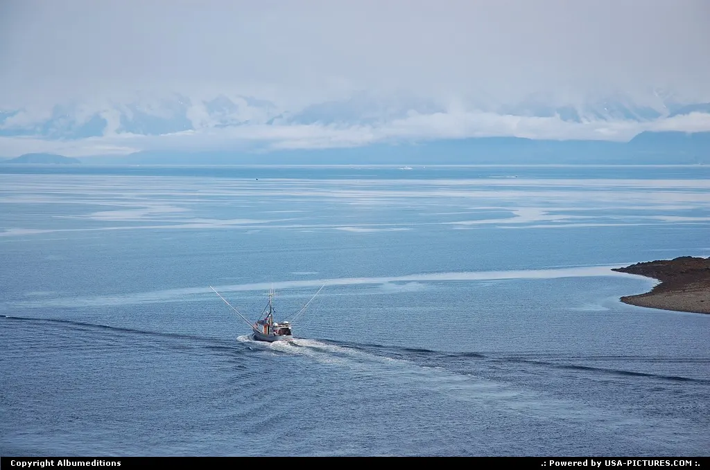 A fishing boat is leaving Hoonah harbour.