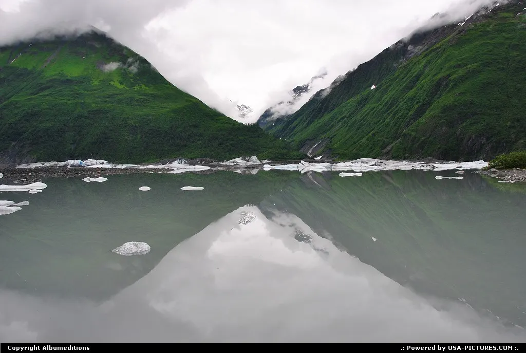 Ice from Valdez Glacier drifts in the grey water of Lake Valdez.