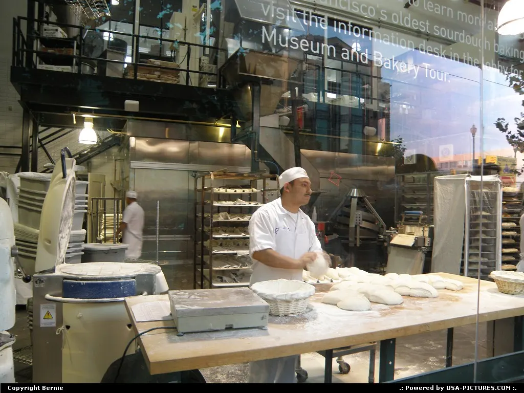baker at work behind the glass of BOUDIN bakery (fisherman's wharf)