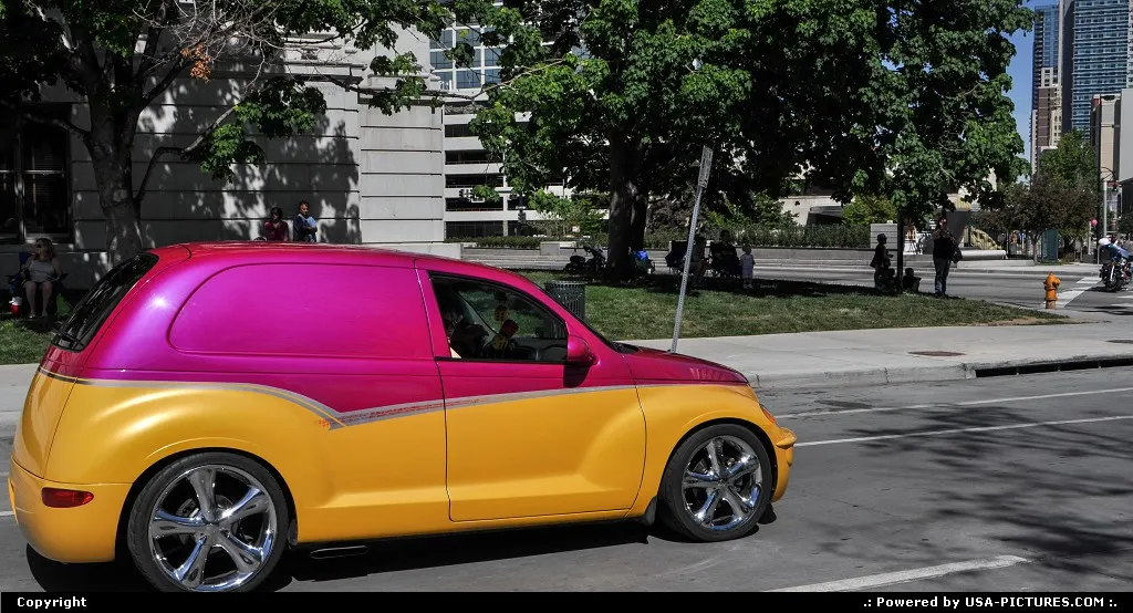 All American PT Cruiser parading in front of the City all in downtown Denver.