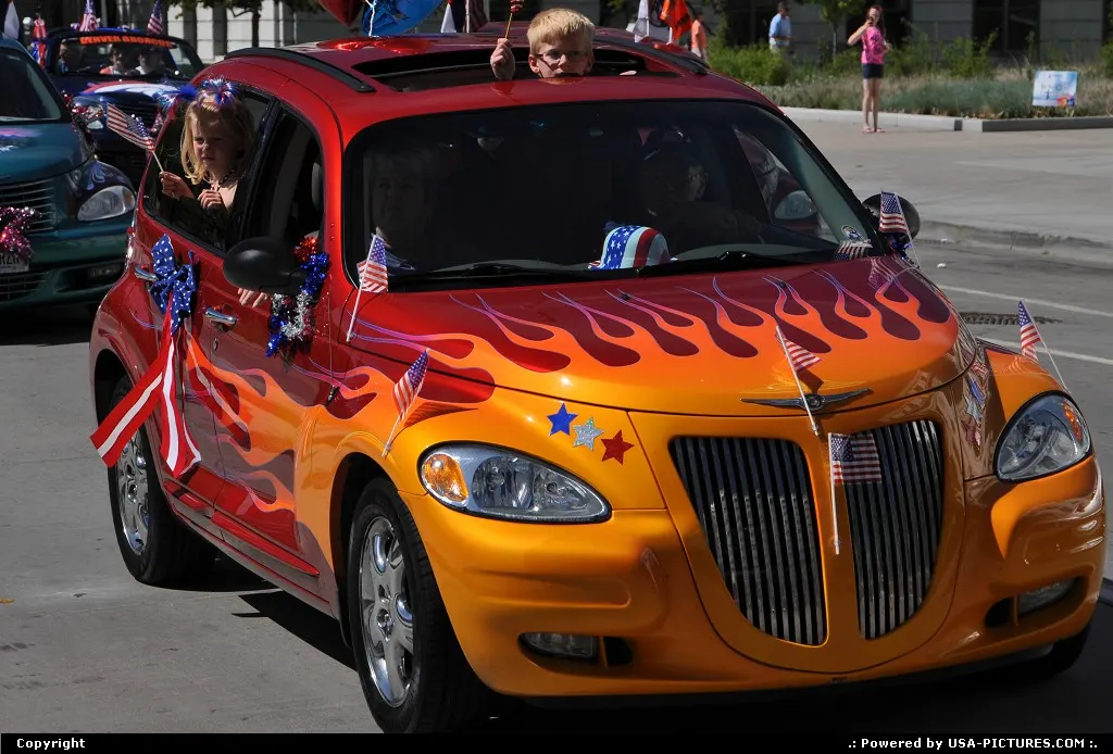 All American PT Cruiser parading in front of the City all in downtown Denver.
