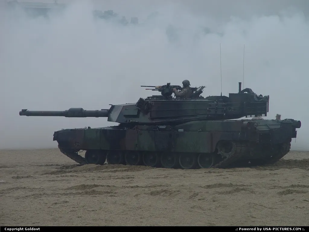 Under smoke cover. M1A2 supports the infantry.