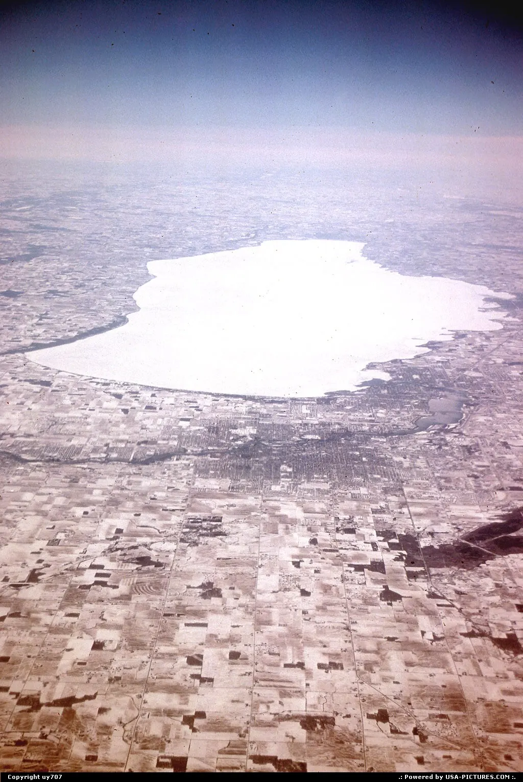 Prime view on a snow capped landscape doted by frozen lakes while en route from Newark/...