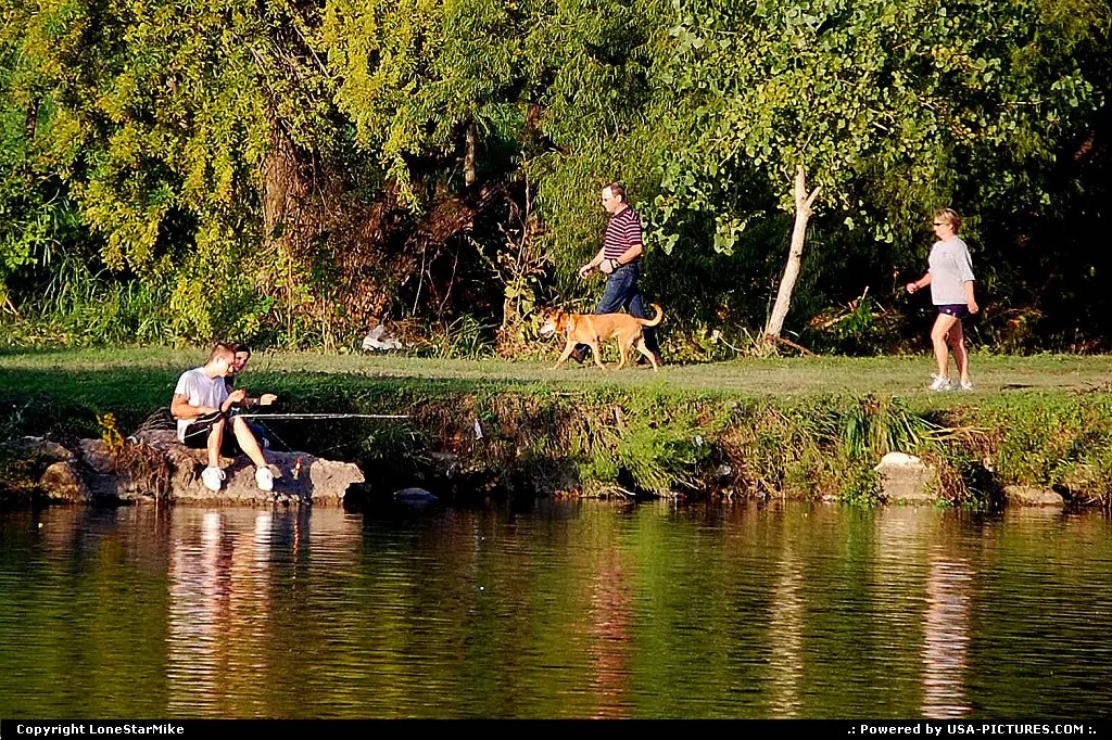 People enjoying the Lady Bird Lake Hike and Bike Trail.