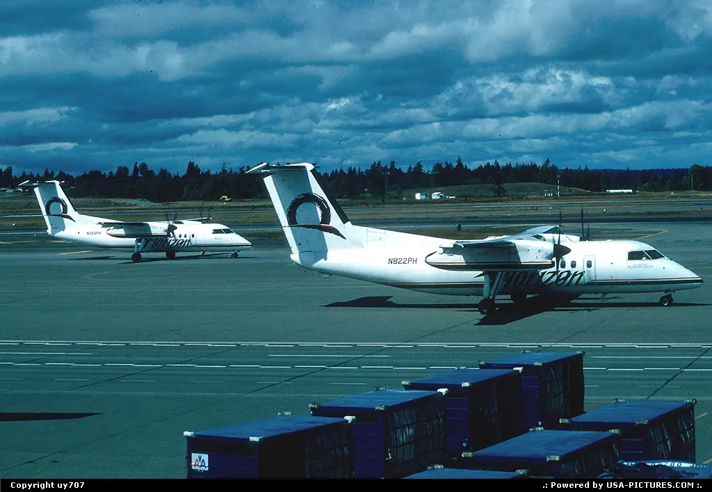 A couple of Horizon Air DeHavillandCanada Dash-8.200s depart one of SeaTac/Seattle Taco...
