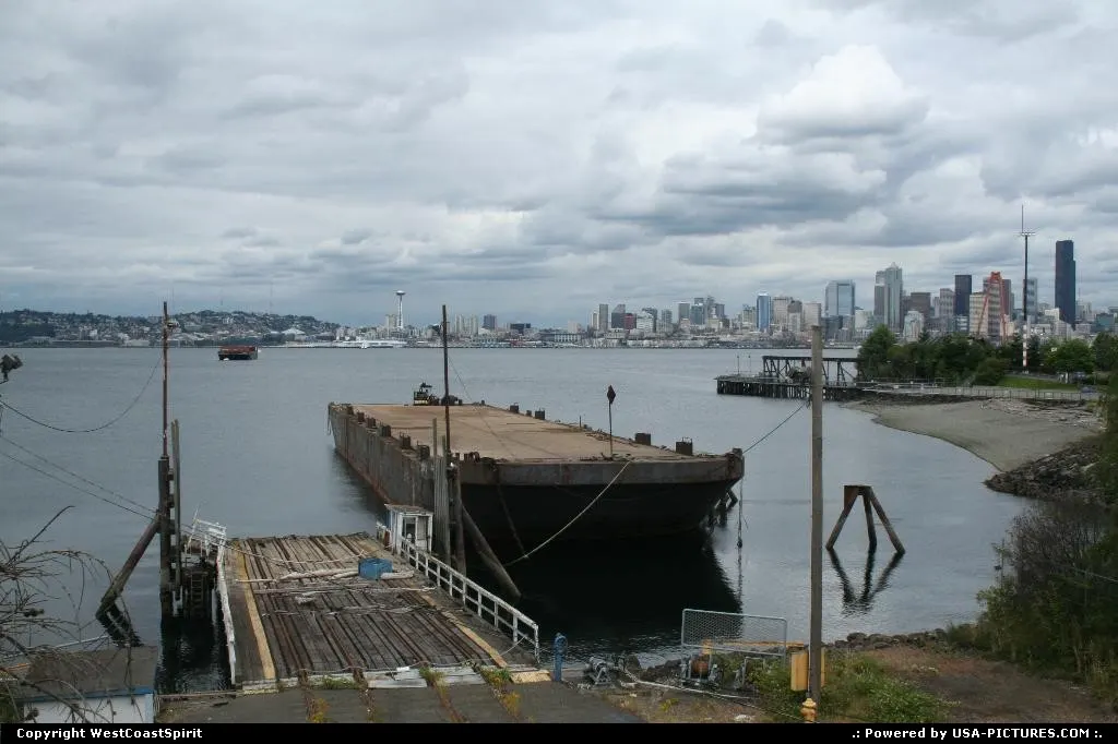 A barge awaiting its fate on Elliott Bay, with the Seattle skyline afar.