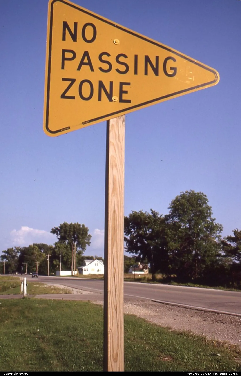 The Do-not-pass road sign turns into a triangle after crossing the