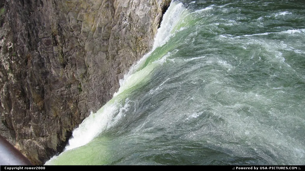 Green waters roar into the abyss at the brink of the Lower Falls into the Grand Canyon...